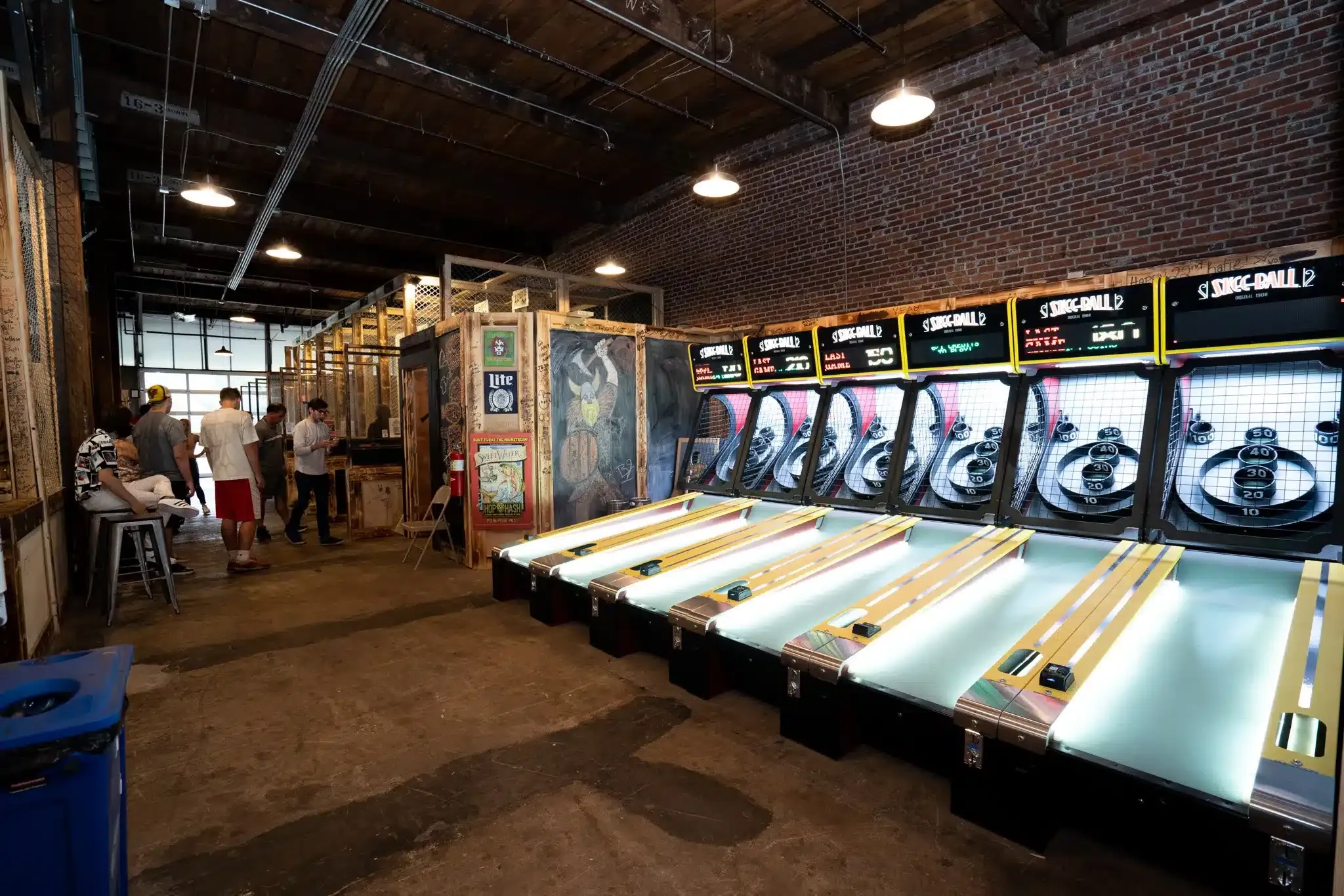 Arcade games and entertainment area at a Craft Axe venue