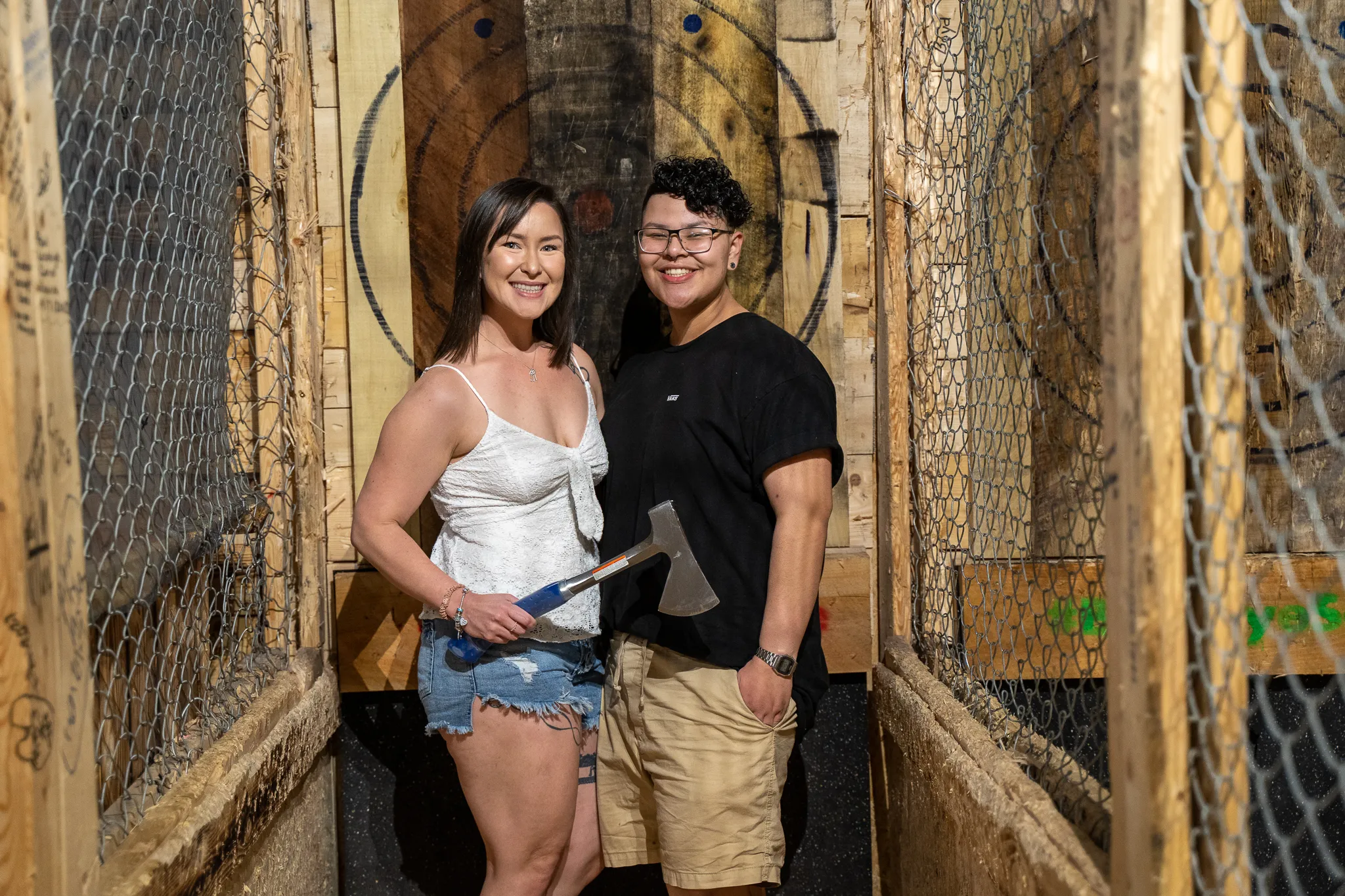 Couple competing in a weekly axe throwing league night
